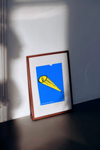 Framed artwork with a blue background and yellow element on a white wall. Plantman, limited edition giclée print by Jimmy Hutch